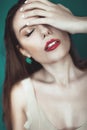 Close-up of beautiful wet woman face with water drop. On green b Royalty Free Stock Photo