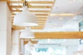 Close up of beautiful white simply modern ceiling lamps in restaurant with blurry background copy space