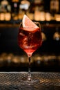 close-up of beautiful wine glass with bright cold iced drink decorated with citrus slice