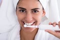 Beautiful Woman In Bathrobe Brushing Teeth Royalty Free Stock Photo