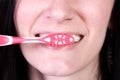 Close up of a beautiful woman brushing her teeth Royalty Free Stock Photo