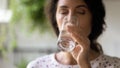 Close up beautiful woman drinking fresh mineral water, holding glass Royalty Free Stock Photo