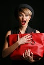 Close up of a beautiful woman with a good sense of humor , holding her fancy red bag. Royalty Free Stock Photo
