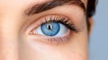Close up of a beautiful woman\'s blue eye with a contact lens, in a macro shot Royalty Free Stock Photo