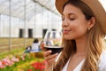 Close-up of beautiful woman smelling red wine from glass with closed eyes Royalty Free Stock Photo