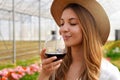 Close-up of beautiful woman smelling red wine from glass with closed eyes Royalty Free Stock Photo