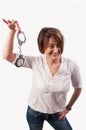 Close up of a beautiful woman smiling and showing handcuffs Royalty Free Stock Photo