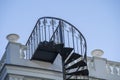 Beautiful wrought iron exterior spiral staircase on the side of a house Royalty Free Stock Photo