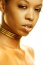 Close up of a beautiful young African American model in golden light Royalty Free Stock Photo