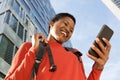 Close up beautiful young african american woman looking at cellphone in city Royalty Free Stock Photo