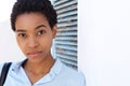 Close up beautiful young african woman leaning against wall Royalty Free Stock Photo