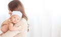 Close up beautiful young asian mother holding her newborn one month baby sleep on her shoulder. Healthcare and medical. Lovely