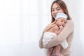 Close up beautiful young asian mother holding her newborn one month baby sleep on her shoulder. Healthcare and medical.  Lovely Royalty Free Stock Photo