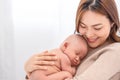 Close up beautiful young asian mother holding her newborn one month baby sleep on herlap. Healthcare and medical.  Lovely asia Royalty Free Stock Photo
