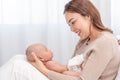 Close up beautiful young asian mother holding her newborn one month baby sleep on herlap. Healthcare and medical.  Lovely asia Royalty Free Stock Photo