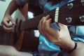 Close up beautiful young Asian woman`s hand playing acoustic guitar while sitting on sofa at home. Musician lifestyle concept. Royalty Free Stock Photo