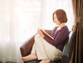 Young asian woman short hair read a book in living room