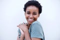Close up beautiful young black woman laughing against white wall Royalty Free Stock Photo