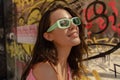 Close-up of beautiful young caucasian female in sunglasses looking at distance outside. Royalty Free Stock Photo