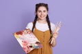 Close up of beautiful young caucasian woman artist with paint brush and colors palette. Female painter with two pigtails holding Royalty Free Stock Photo