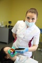 Close up of beautiful young female having dental check up in dental clinic.