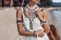 Close up of beautiful young stylish boho woman walking on the beach at sunset Royalty Free Stock Photo