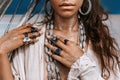 Close up of beautiful young tribal style woman with lots of accessories outdoors