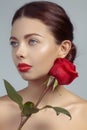 Close-up beautiful young woman with bright lipgloss makeup. Perfect clean skin, red lip make-up. Beautiful valentine visage w Royalty Free Stock Photo