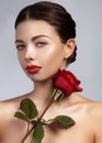 Close-up beautiful young woman with bright lipgloss makeup. Perfect clean skin, red lip make-up. Beautiful valentine visage w Royalty Free Stock Photo