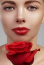 Close-up beautiful young woman with bright lipgloss makeup. Perfect clean skin, red lip make-up. Beautiful valentine visage w Royalty Free Stock Photo