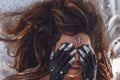 Close up of beautiful young woman cover eyes with hands painted black. night and moon concept Royalty Free Stock Photo