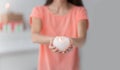 Close up.a beautiful young woman extends a burning candle