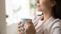 Close up beautiful young woman holding cup, enjoying morning Royalty Free Stock Photo