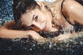 Close up of beautiful young woman lying in the water. Royalty Free Stock Photo