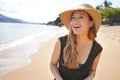 Close-up of a beautiful young woman wearing summer dress and straw hat on the tropical beach Royalty Free Stock Photo