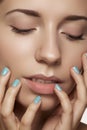 Close-up beauty. Model face with natural make-up & bright manicure