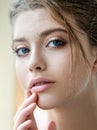 Beautiful young woman with clean perfect skin and water moisture drops touching face Royalty Free Stock Photo