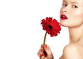 Close-up beauty photo woman with red lips, lipstick and beautiful red flower. Spa clean skin Royalty Free Stock Photo