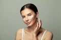 Close up beauty portrait of cute woman applying moisturizing skincare cream, lotion or mask for her skin on grey background Royalty Free Stock Photo