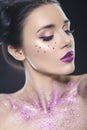 Close up beauty portrait of a fantasy art theme: Star Wars cosplay. Princess Leia hairstyle with purple glitters and stars all Royalty Free Stock Photo