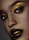 Close up beauty portrait of girl with creative golden makeup and golden teeth