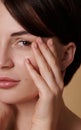 Close-up beauty portrait of a half of face of beautiful brunette woman with perfect healthy shiny clean skin touching and Royalty Free Stock Photo