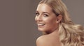 Close up beauty portrait of a laughing beautiful half naked caucasian woman with long blonde hair isolated over light Royalty Free Stock Photo