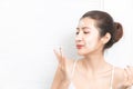 Close up beauty portrait of a smiling beautiful half naked woman applying face cream in bathroom Royalty Free Stock Photo