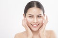 Close up beauty portrait of a young beautiful smiling woman applying face cream over white background studio Royalty Free Stock Photo