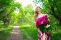 Close-up beauty portrait of young pretty girl with flower peony wearing bright pink lipstick, touching her lips. Bright Royalty Free Stock Photo