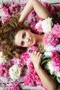 Close up beauty portrait of a young woman with pink peones. Royalty Free Stock Photo