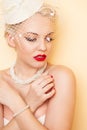 Close-up beauty portrait of young woman with red lips, long false eyelashes and white retro hat with mesh Royalty Free Stock Photo