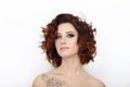 Close up beauty studio shot of beautiful redhead woman with gorgeous makeup curly hair