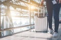 Close up of beauty woman traveling and holding trolley suitcase in airport. People and Lifestyles concept. Travel around the world Royalty Free Stock Photo